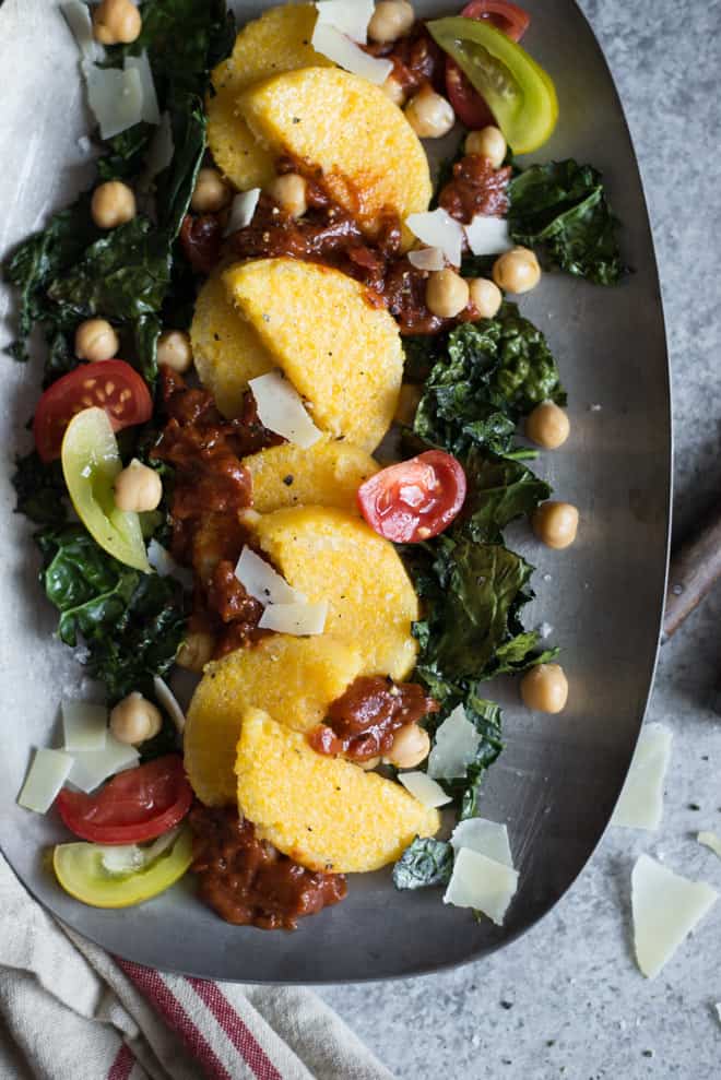 Pan Fried Polenta with Roasted Kale and Chickpeas - topped with tomatoes and parmesan cheese, this is the perfect light gluten-free dinner! Made with just 6 ingredients! by @healthynibs